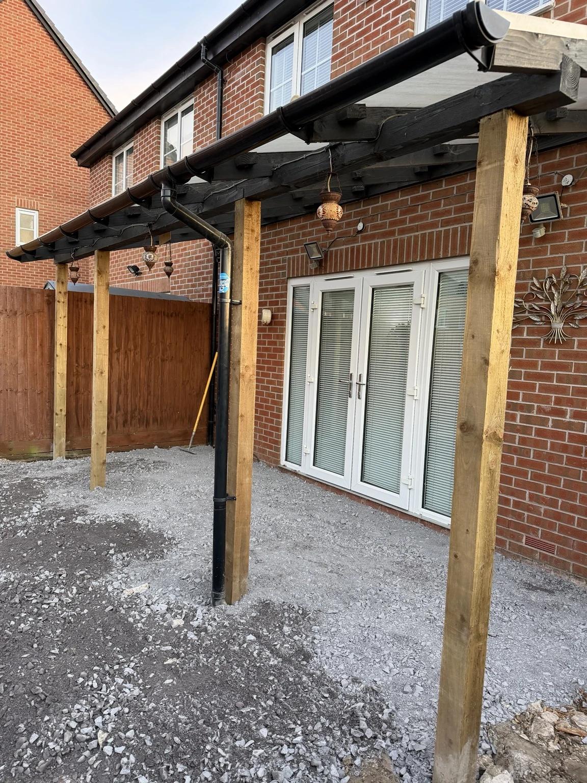 Replacement lean-to posts and prepared sub-base after the old decking was removed