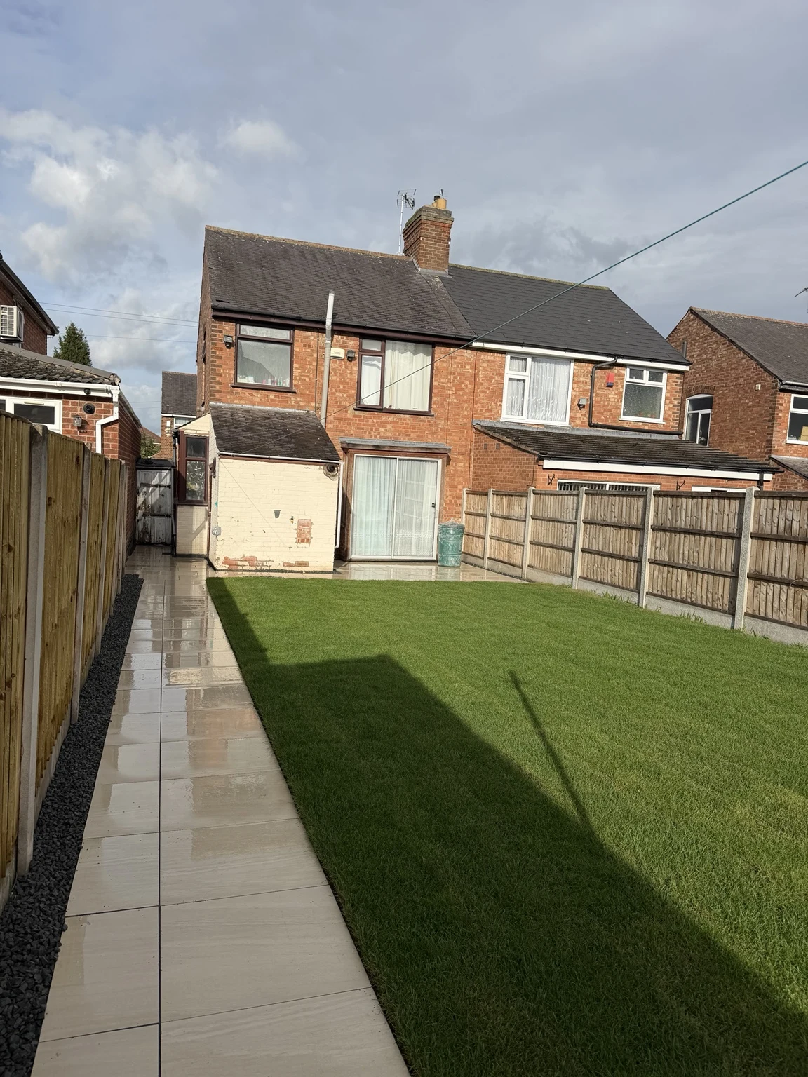 New turf and porcelain path towards the rear doors