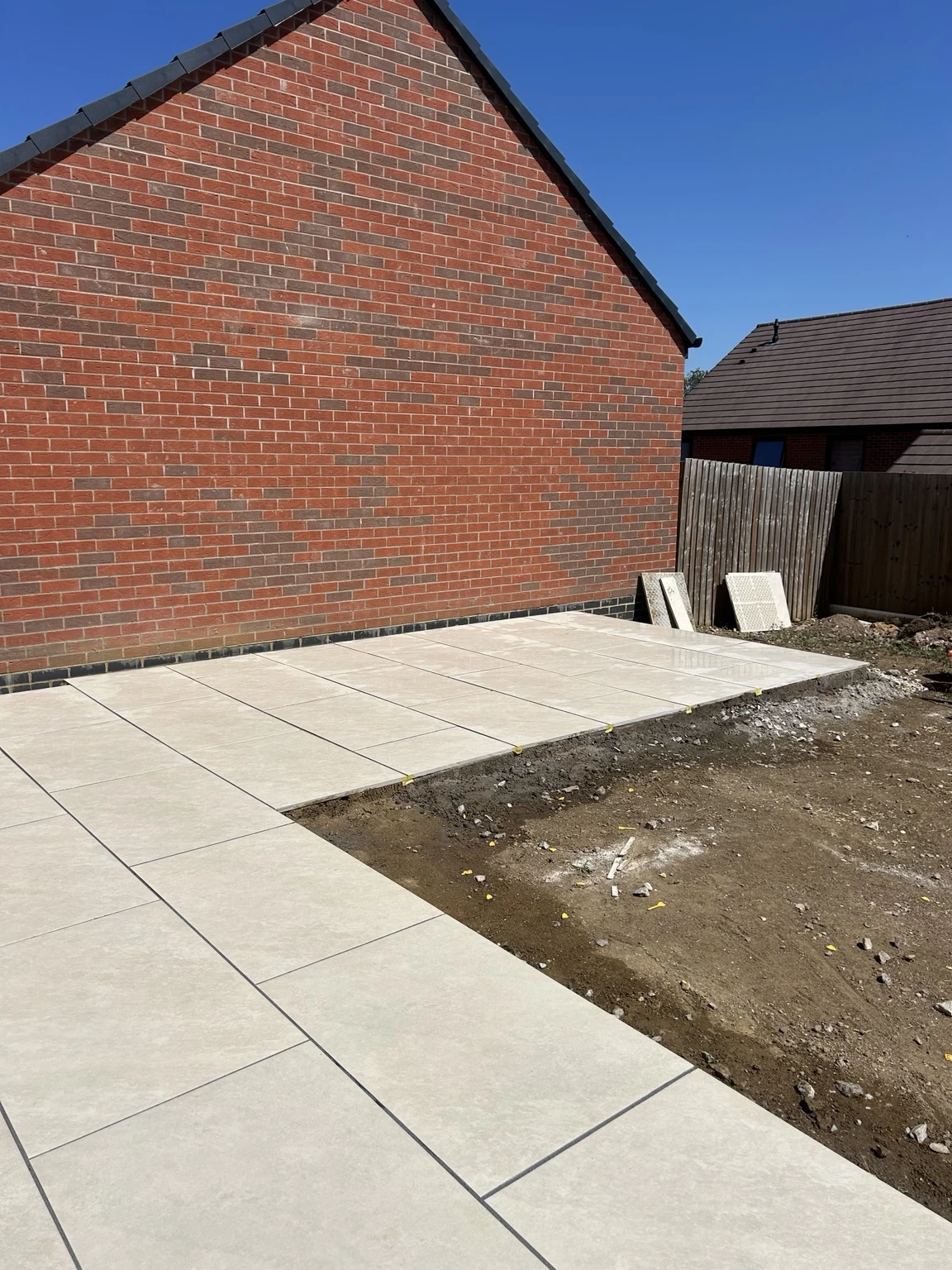 Porcelain patio surrounding the cleared garden at the earlier paving stage