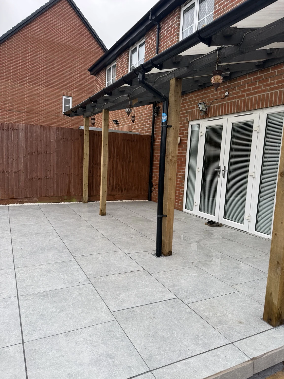 Detail of the completed porcelain paving and neatly fitted cuts around the posts